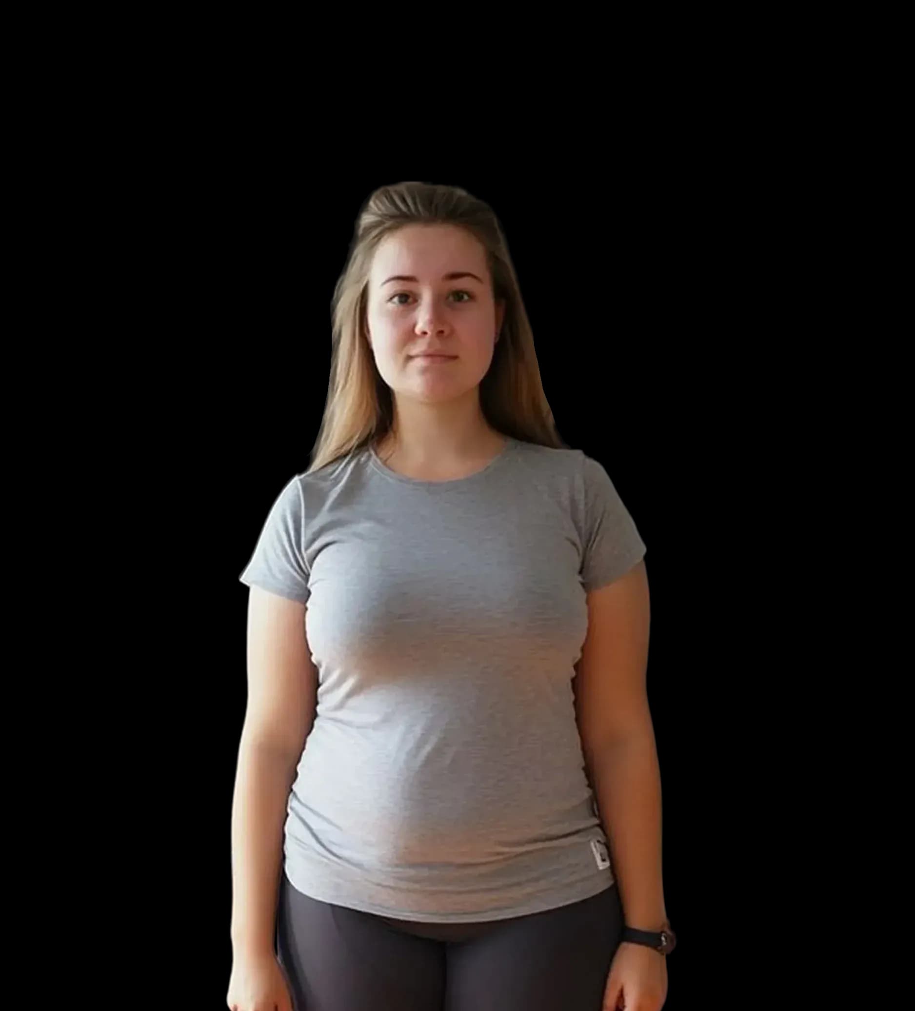 Young woman with light brown hair wearing a grey t-shirt and dark pants.